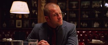 Movie still from “Ocean's Twelve” (2004), directed by Steven Soderbergh – A person sitting at a table; Close Up shot, Over the shoulder angle