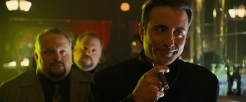 Movie still from “Ocean's Twelve” (2004), directed by Steven Soderbergh – A man holding a cigarette in front of another man; Close Up shot, Over the shoulder angle