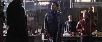 Movie still from “Ocean's Twelve” (2004), directed by Steven Soderbergh – A man standing in front of another man in a workshop; Medium shot, Low angle