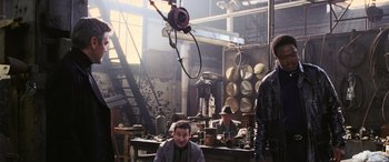 Movie still from “Ocean's Twelve” (2004), directed by Steven Soderbergh – A group of men working in an industrial setting; Medium shot, Low angle