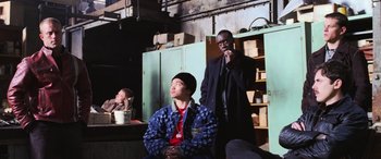 Movie still from “Ocean's Twelve” (2004), directed by Steven Soderbergh – A man standing next to another man in a room; Medium shot, Over the shoulder angle