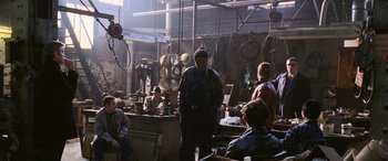 Movie still from “Ocean's Twelve” (2004), directed by Steven Soderbergh – A group of people sitting in a room with pots and pans on the floor; Wide shot, High angle