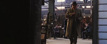 Movie still from “Ocean's Twelve” (2004), directed by Steven Soderbergh – A group of people in a room with a man in a hat; Wide shot, High angle