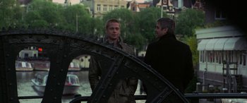 Movie still from “Ocean's Twelve” (2004), directed by Steven Soderbergh – Two men standing next to each other on a bridge; Medium shot, Over the shoulder angle