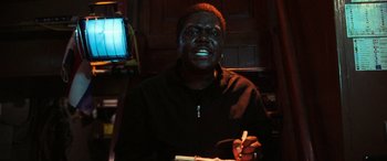 Movie still from “Ocean's Twelve” (2004), directed by Steven Soderbergh – A man is writing in a notebook in a dark room; Close Up shot, Low angle