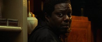 Movie still from “Ocean's Twelve” (2004), directed by Steven Soderbergh – A person wearing a black jacket; Close Up shot, Over the shoulder angle