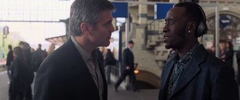 Movie still from “Ocean's Twelve” (2004), directed by Steven Soderbergh – Two men talking to each other on a sidewalk; Close Up shot, Over the shoulder angle