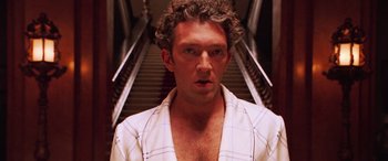 Movie still from “Ocean's Twelve” (2004), directed by Steven Soderbergh – A person wearing a robe near some stairs; Close Up shot, Low angle