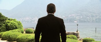 Movie still from “Ocean's Twelve” (2004), directed by Steven Soderbergh – A man in a suit looking out over a lake; Medium shot, Low angle