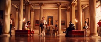 Movie still from “Ocean's Twelve” (2004), directed by Steven Soderbergh – A group of people standing in front of a painting in a museum; Wide shot, Low angle
