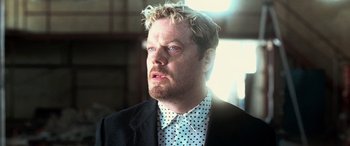 Movie still from “Ocean's Twelve” (2004), directed by Steven Soderbergh – A person wearing a suit and tie; Close Up shot, Low angle