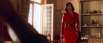 Movie still from “Ocean's Twelve” (2004), directed by Steven Soderbergh – A woman in a red dress holding a purse; Medium shot, Over the shoulder angle