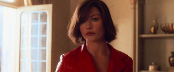 Movie still from “Ocean's Twelve” (2004), directed by Steven Soderbergh – A person wearing a red jacket; Close Up shot, Over the shoulder angle