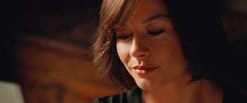 Movie still from “Ocean's Twelve” (2004), directed by Steven Soderbergh – A person with her eyes closed; Close Up shot, Over the shoulder angle