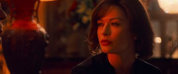 Movie still from “Ocean's Twelve” (2004), directed by Steven Soderbergh – A person sitting in front of a window; Close Up shot, Over the shoulder angle