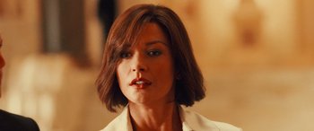 Movie still from “Ocean's Twelve” (2004), directed by Steven Soderbergh – A person with short brown hair; Close Up shot, Over the shoulder angle