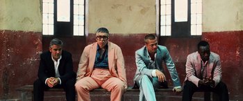 Movie still from “Ocean's Twelve” (2004), directed by Steven Soderbergh – A couple of men sitting next to each other on a bench; Wide shot, Low angle