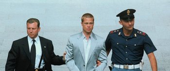 Movie still from “Ocean's Twelve” (2004), directed by Steven Soderbergh – A man in a suit standing next to two other men; Medium shot, Over the shoulder angle