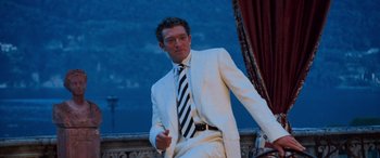 Movie still from “Ocean's Twelve” (2004), directed by Steven Soderbergh – A man in a white suit and a black and white striped tie; Medium shot, Low angle