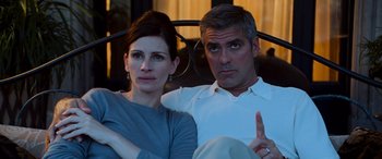 Movie still from “Ocean's Twelve” (2004), directed by Steven Soderbergh – A man and a woman sitting next to each other; Close Up shot, Over the shoulder angle