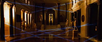 Movie still from “Ocean's Twelve” (2004), directed by Steven Soderbergh – A room filled with statues and lights in a building; Extreme Wide shot, High angle
