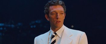 Movie still from “Ocean's Twelve” (2004), directed by Steven Soderbergh – A person wearing a suit and tie; Close Up shot, Low angle