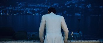 Movie still from “Ocean's Twelve” (2004), directed by Steven Soderbergh – A man in a white suit looking out over the water; Medium shot, Over the shoulder angle