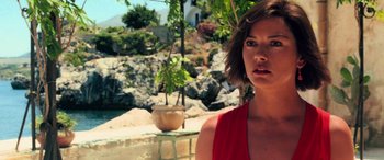 Movie still from “Ocean's Twelve” (2004), directed by Steven Soderbergh – A woman in a red top standing in front of a rock wall; Close Up shot, Low angle