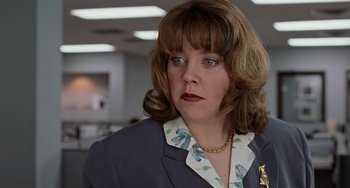 Movie still from “Office Space” (1999), directed by Mike Judge – A person wearing a suit and tie; Close Up shot, Low angle