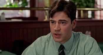 Movie still from “Office Space” (1999), directed by Mike Judge – A person wearing a shirt and a tie; Close Up shot, Over the shoulder angle