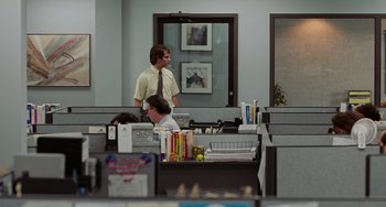 Movie still from “Office Space” (1999), directed by Mike Judge – Two men are standing in an office cubicle; Wide shot, Over the shoulder angle
