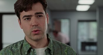 Movie still from “Office Space” (1999), directed by Mike Judge – A person wearing a green shirt; Close Up shot, Over the shoulder angle