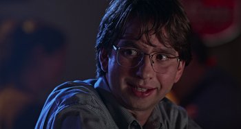 Movie still from “Office Space” (1999), directed by Mike Judge – A person wearing glasses; Close Up shot, Low angle