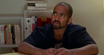 Movie still from “Office Space” (1999), directed by Mike Judge – A person sitting at a table; Close Up shot, High angle