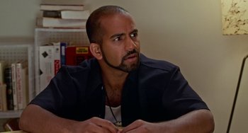 Movie still from “Office Space” (1999), directed by Mike Judge – A man with a beard is sitting at a table; Close Up shot, High angle