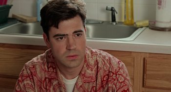 Movie still from “Office Space” (1999), directed by Mike Judge – A person sitting in front of a sink; Close Up shot, Over the shoulder angle