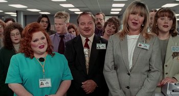 Movie still from “Office Space” (1999), directed by Mike Judge – A group of people standing in front of each other in a room; Medium shot, Low angle