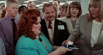 Movie still from “Office Space” (1999), directed by Mike Judge – A group of people standing around a room; Medium shot, Over the shoulder angle