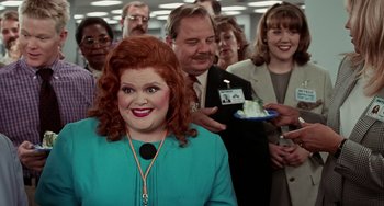 Movie still from “Office Space” (1999), directed by Mike Judge – A group of people standing around a woman with red hair; Medium shot, Over the shoulder angle