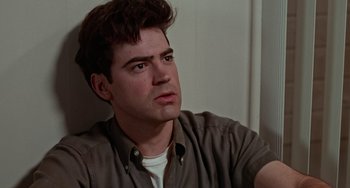 Movie still from “Office Space” (1999), directed by Mike Judge – A person wearing a brown shirt; Close Up shot, Low angle