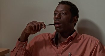 Movie still from “Office Space” (1999), directed by Mike Judge – A man brushing his teeth with an electric toothbrush; Close Up shot, High angle