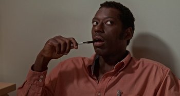 Movie still from “Office Space” (1999), directed by Mike Judge – A man brushing his teeth with an electric toothbrush; Close Up shot, High angle