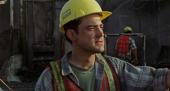 Movie still from “Office Space” (1999), directed by Mike Judge – A construction worker wearing a hard hat and safety vest; Close Up shot, Low angle