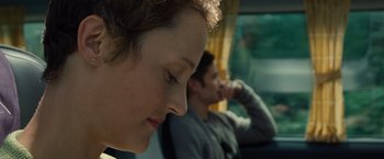 Movie still from “Old” (2021), directed by M. Night Shyamalan – A woman sitting next to a man on a bus; Close Up shot, Over the shoulder angle