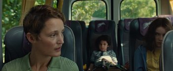 Movie still from “Old” (2021), directed by M. Night Shyamalan – A woman and a boy sitting on a bus; Close Up shot, Over the shoulder angle