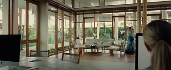 Movie still from “Old” (2021), directed by M. Night Shyamalan – A living room filled with lots of furniture and large windows; Wide shot, High angle