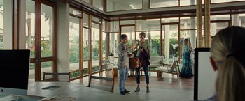 Movie still from “Old” (2021), directed by M. Night Shyamalan – A man and a woman standing in front of a window; Wide shot, Low angle