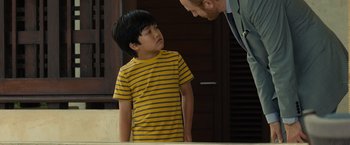 Movie still from “Old” (2021), directed by M. Night Shyamalan – A man and a boy are standing in front of a mirror; Medium shot, Over the shoulder angle