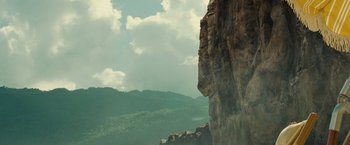 Movie still from “Old” (2021), directed by M. Night Shyamalan – A large cliff with a view of the mountains; Extreme Wide shot, Low angle