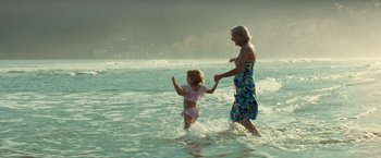 Movie still from “Old” (2021), directed by M. Night Shyamalan – An older woman and a young girl in the ocean; Wide shot, Low angle